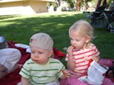 Cousins eating Cheetos on a picnic